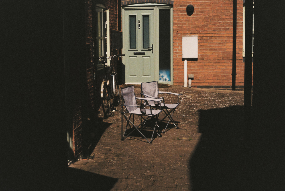 Two picnic chairs and a bike.