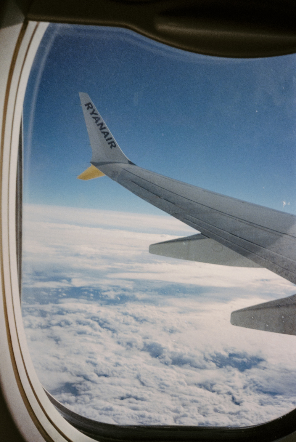 Airplane wing above clouds